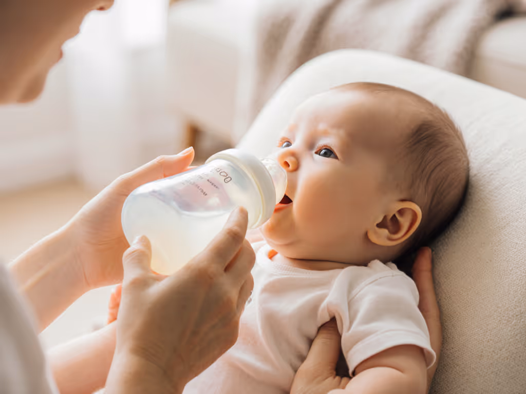 breastfed baby happily accepting bottle